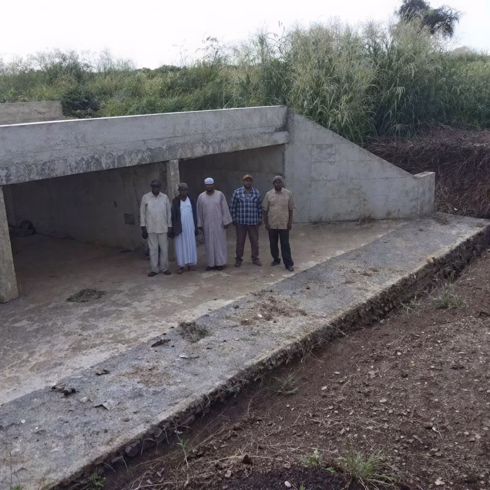 Project team standing inside the finished culvert cells at Gadareef.